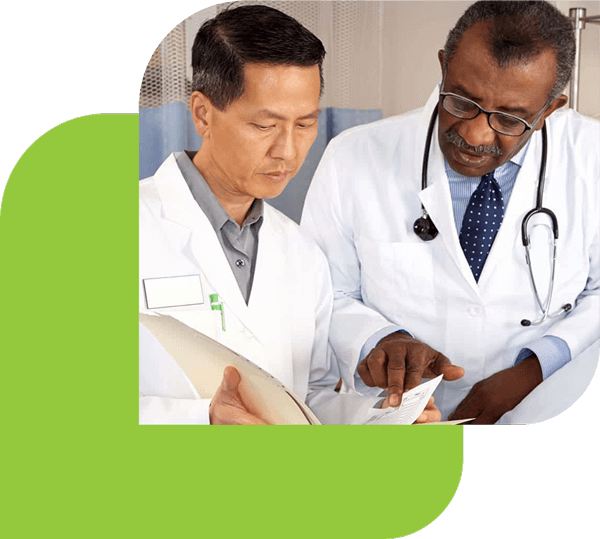 Two doctors reviewing a medical file together. Styled within the Revibe logo